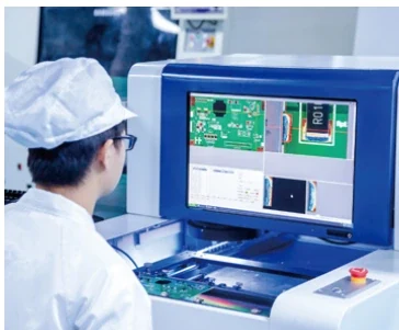 Technician inspecting a circuit board on the production line