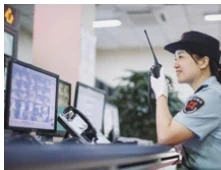 Control room operator coordinating security teams by radio
